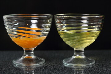Two glass bowls. One with egg yolks, other with egg whites.