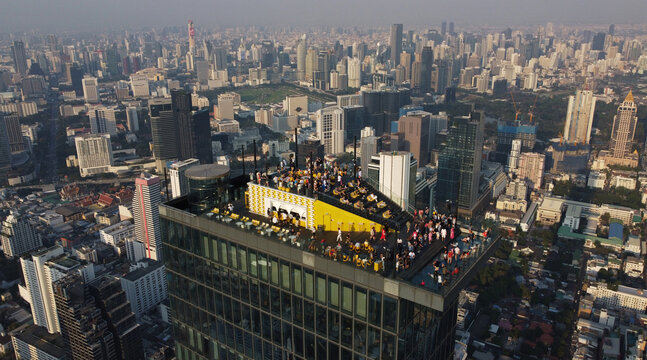 Aerial view of King Power Mahanakhon building skywalk rooftop bar in Bangkok, Thailand. Mahanakhon skyscraper is currently Thailand's tallest at 314 meters, has a 360 degree view of Bangkok.