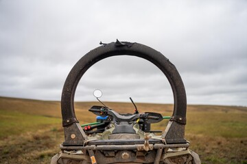 quad bike with a crush protection rollbar installed for safety in australia. australian motorbike in a field on a farm - obrazy, fototapety, plakaty