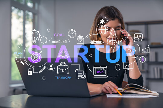 Pensive attractive beautiful businesswoman in formal wear working on laptop at office workplace in background. Concept of start up new business technology. Rocket icon hologram. Talking phone.