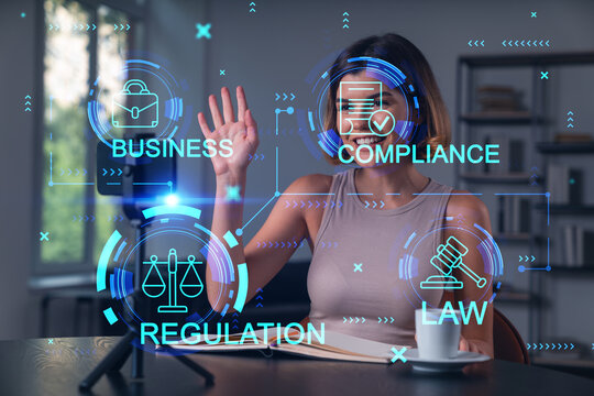 Happy woman is making video blog using smartphone on a tripod explaining with hands at office workplace. Concept of online stream, business education, conference call. Legal hologram