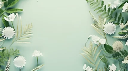 Fotobehang A serene collection of white flowers and green leaves arranged in a circular frame on a pastel green backdrop. © tashechka
