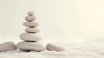 Poster Zen stones, balance stones on the white sand, on a blurred background. Concept of calm, relaxation and meditative state © Natalia S.