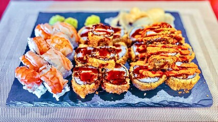 Sushi set on a black plate, close-up, top view