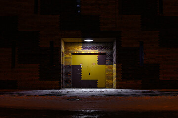 Yellow brown double-leaf gate on a winter evening