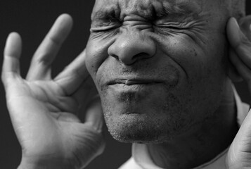 deafness suffering from hearing loss on grey black background with people stock image stock photo	