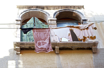 Gorgeous Venice. The narrow street channel. Picturesque laundry drying on clothesline