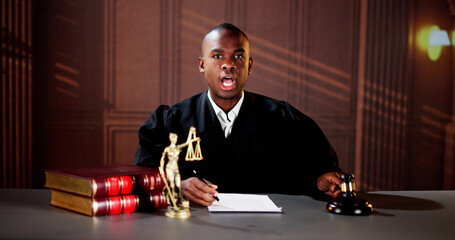 Confident Mature Male Judge Striking The Gavel