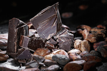 Broken dark chocolate and coffee beans on a table