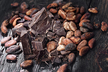 Broken dark chocolate and coffee beans on a table