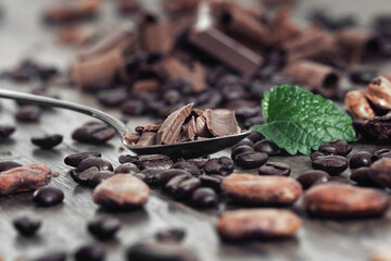 Broken dark chocolate and coffee beans on a table