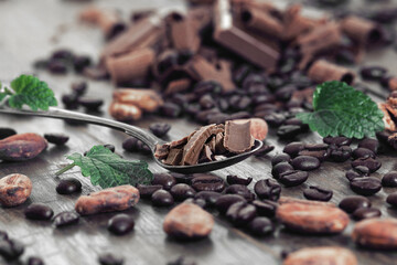 Broken dark chocolate and coffee beans on a table