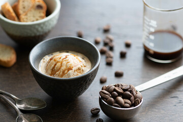 Italian affogato in a ceramic cup on a dark background. Ice cream and coffee, selective focus
