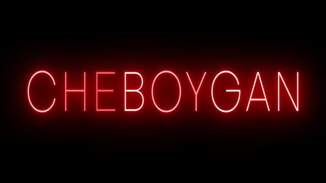 Flickering red retro style neon sign glowing against a black background for CHEBOYGAN