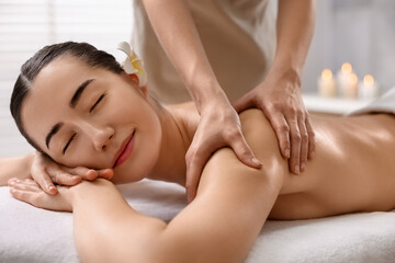 Woman receiving massage on couch in spa salon