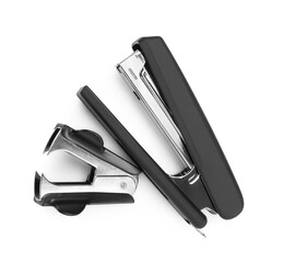 Black stapler and staple remover isolated on white, top view