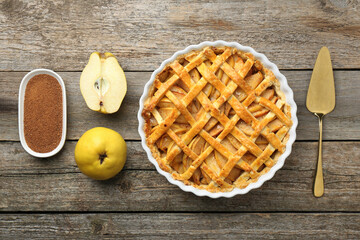 Tasty homemade quince pie, ingredients and cake server on wooden table, flat lay