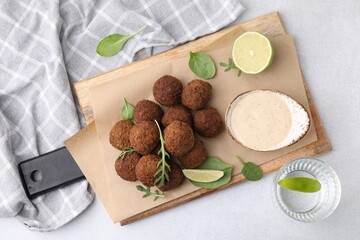 Delicious falafel balls served on light table, top view