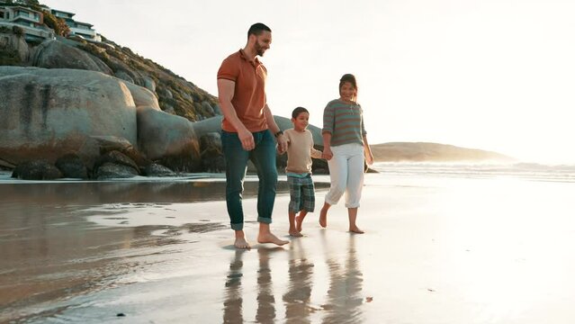 Beach, walking and child holding hands with parents for adventure, fun or bonding together. Happy, sunset and boy kid with young mom and dad by ocean on tropical vacation, holiday or weekend trip.