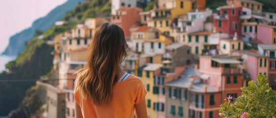 Obraz premium Woman gazing at a picturesque Italian coastal village, a blend of culture and stunning views