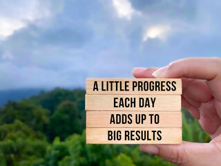 'A little progress each day adds up to big results' text background. Inspirational quote concept.