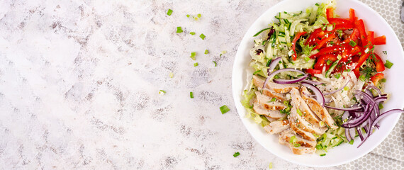 Fresh  salad  with grilled chicken breast, fillet and lettuce, daikon, red onions, cucumber and sesame. Healthy lunch menu. Diet food. Top view