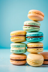 Macaroons stacked on light blue background
