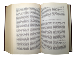 An old used German bible. It's opened at the Gospel of John. Transparent background.