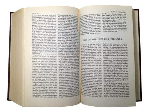 An old used German bible. It's opened at the Gospel of John. Transparent background. - Powered by Adobe
