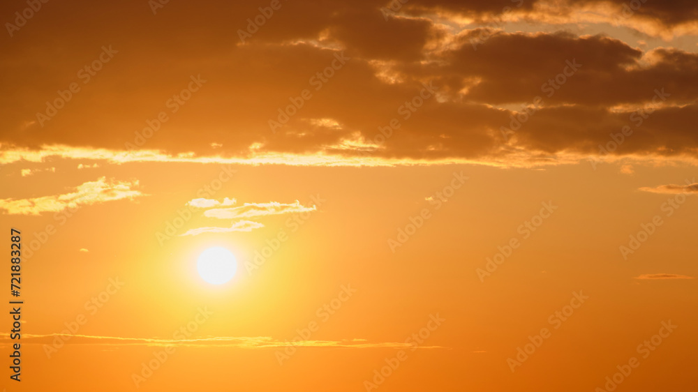Wall mural sunset in the sky with clouds and rays of the setting sun