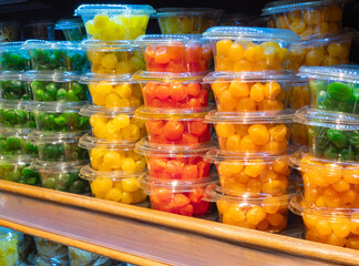 Candied citrus fruits kumquat in a containers on a store shelf. Candied kumquat, candied fruit,...