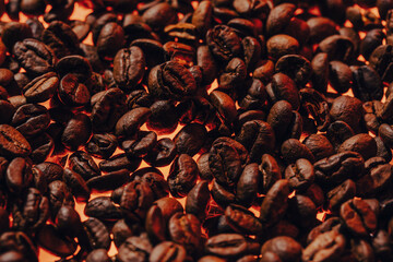 Roasted coffee beans with smoke and fire background. Close up,