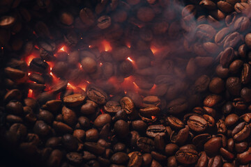Roasted coffee beans with smoke and fire background. Close up,