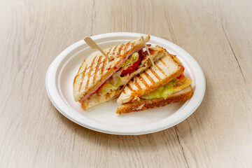 Sandwich with meat. On a light wooden background.
