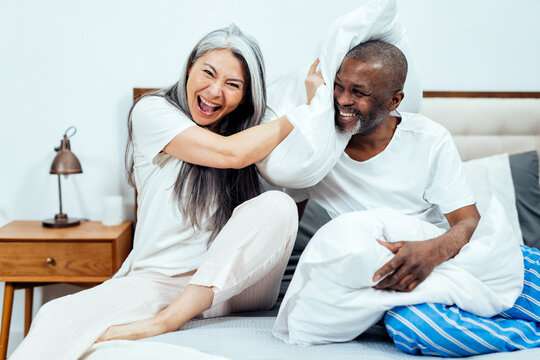 Cinematic image of an happy multiethnic senior couple.