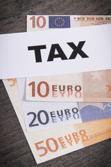 Obraz premium Inscription tax and euro banknotes. Time of calculating, return or tax payment