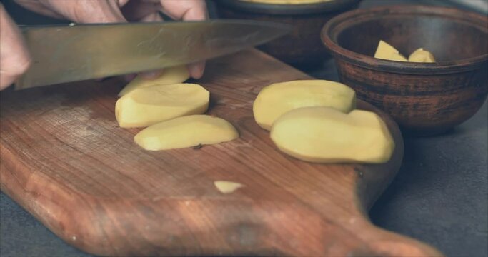 Baking chopped potatoes in the oven. Spices, clay pots. Cinema