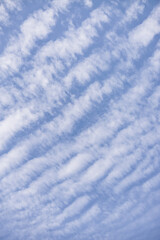 Minimalistic cloudy daytime blue sky with cirrus rhythmic clouds for background