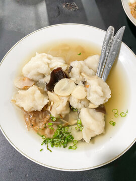 Tekwan is a typical Palembang food meatballs made from a mixture of fish meat and tapioca served with vermicelli, sliced jicama, mushrooms, sprinkled spring onions, celery and fried shallots.
