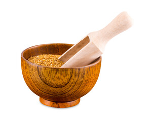 Brown flax seeds in a wooden bowl and spoon isolated on white background