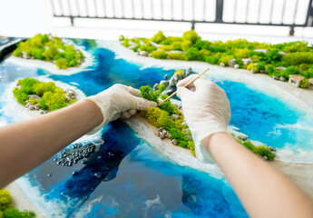 The process of making the art decor of epoxy resin, natural stones and moss