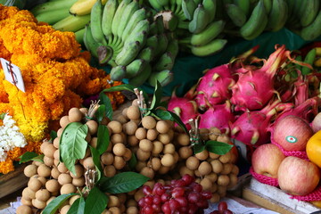 Langsat, Dragon Fruit, Bananas and Flowers on a Market Stall in Cambodia