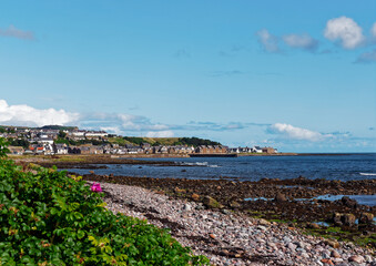Fototapeta na wymiar The Fishing Village of Gourdon on Scotlands East Coast under clear blue skies on a sunny day in September with Calm seas at low tide.