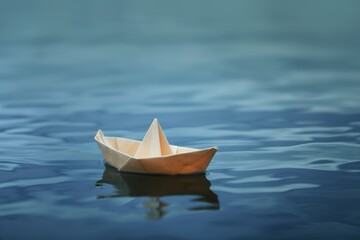 A solitary paper boat glides effortlessly on the tranquil waters of the lake, its reflection a poignant reminder of the simple beauty and peacefulness of outdoor transport