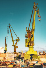 High cranes in the Gdańsk Stocznia, old shipyard - obrazy, fototapety, plakaty
