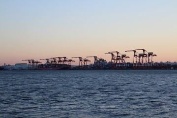 Gantry cranes and cargo ships in dusk at Oi Container Terminal in Tokyo, Japan