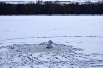 headless snowman on a snow lake on a winter day