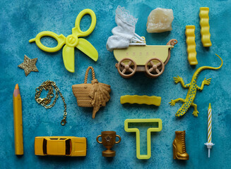 a blue background with a variety of yellow  toys and items