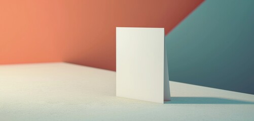 Sleek rectangular bifold brochure card on minimalist triangular table.