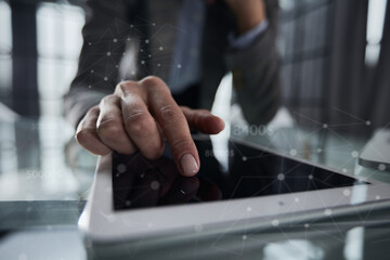 businessman pressing his finger on the screen of the digital tab